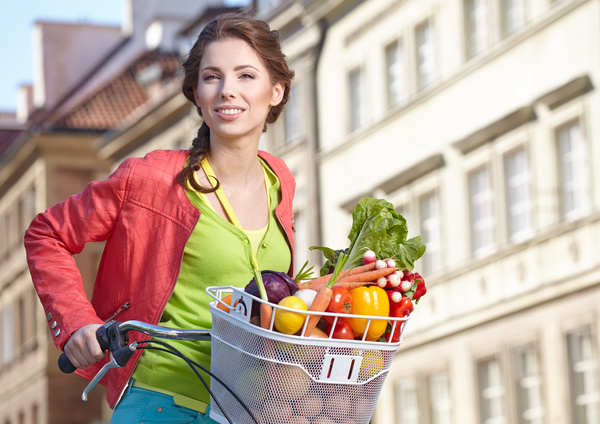 Woman riding a bike to buy food Stock Photo