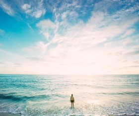 Woman standing in the waves Stock Photo