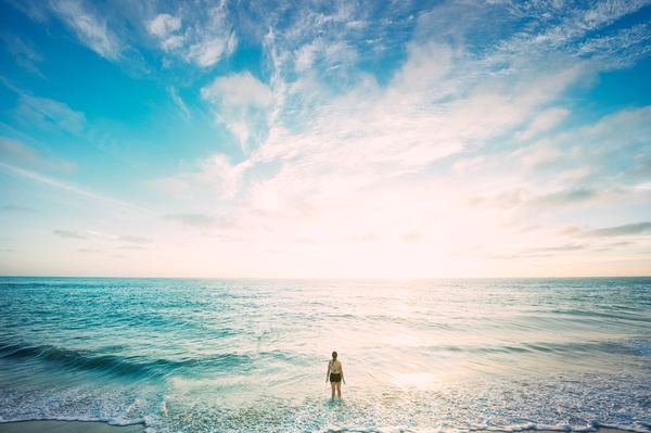 Woman standing in the waves Stock Photo