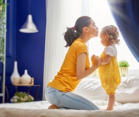 Young mother kissing daughter Stock Photo