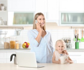 Young mothers calling in the kitchen Stock Photo 02