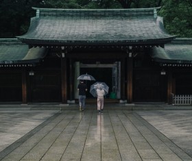 couple walking asia ancient temple under rain Stock Photo