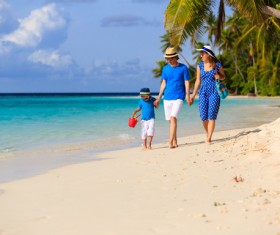 family walking on the beach Stock Photo
