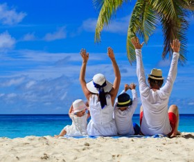 happy family sitting on the beach Stock Photo