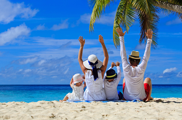 happy family sitting on the beach Stock Photo