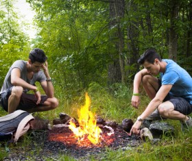 man resting around the campfire Stock Photo