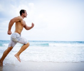 man running on the beach Stock Photo 02