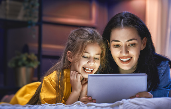 mother and her daughter girl are playing with tablet Stock Photo 02