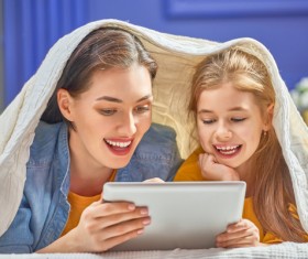 mother and her daughter girl are playing with tablet Stock Photo 03