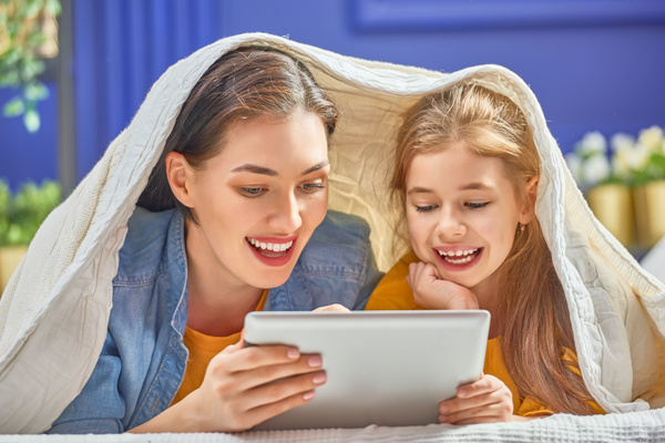 mother and her daughter girl are playing with tablet Stock Photo 03