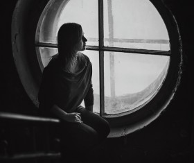 picture of lonely woman and window Stock Photo