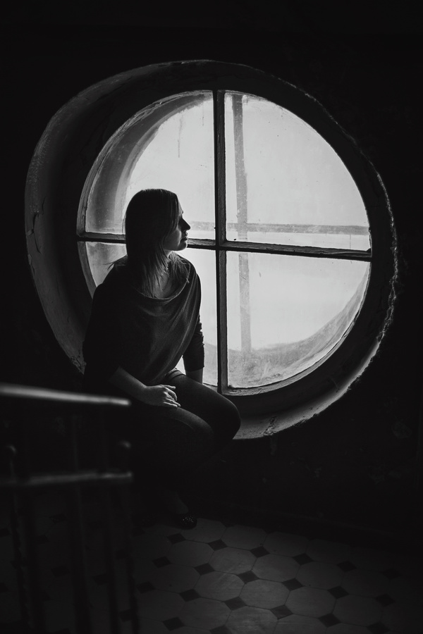 picture of lonely woman and window Stock Photo