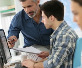 teacher who instructs students to operate a computer Stock Photo 03