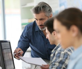 teacher who instructs students to operate a computer Stock Photo 04