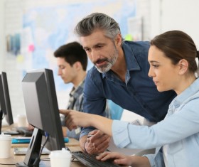 teacher who instructs students to operate a computer Stock Photo 05