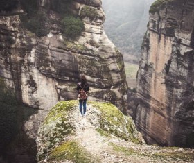 woman standing on the edge of cliff Stock Photo