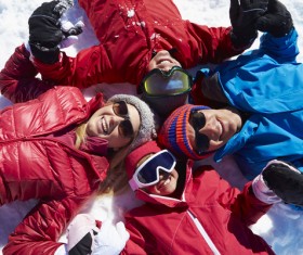 A family lying on the snow Stock Photo