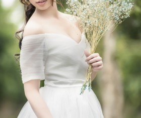 Asia girl hold wildflowers Stock Photo 01