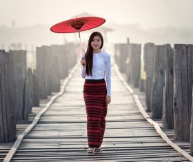 Beautiful Southeast Asia girl with red umbrella Stock Photo