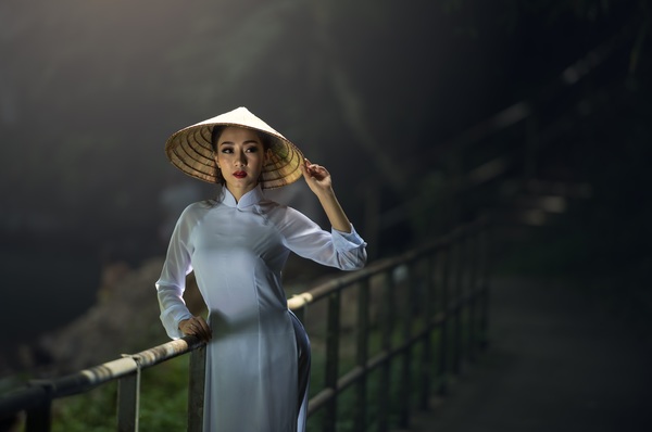 Beautiful Vietnamese girl wearing straw hat Stock Photo