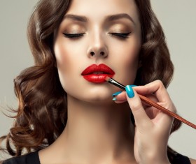 Beautiful woman applying lipstick Stock Photo