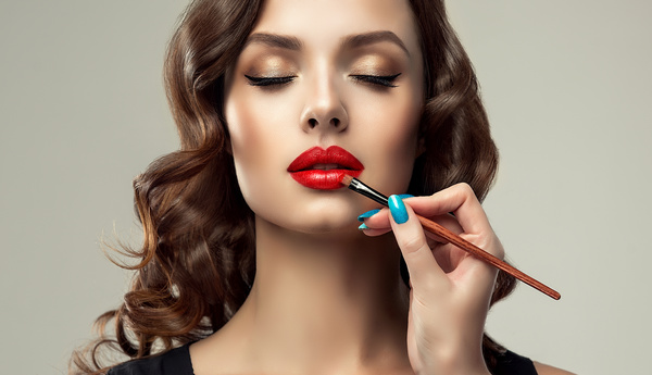 Beautiful woman applying lipstick Stock Photo