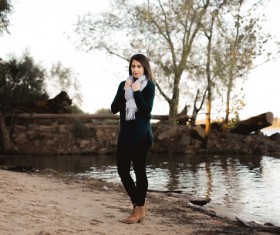 Beautiful woman wearing scarf standing by the river Stock Photo