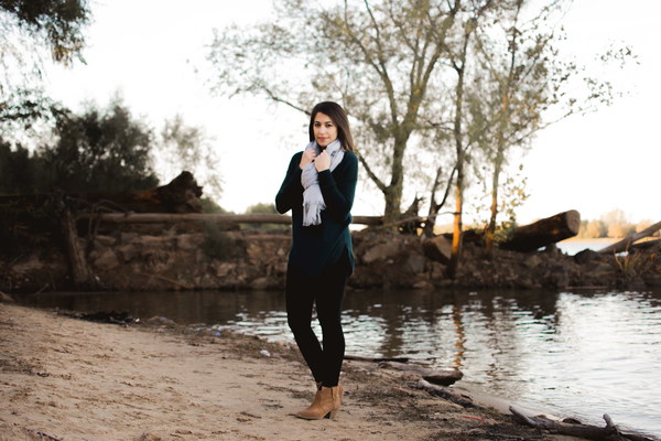 Beautiful woman wearing scarf standing by the river Stock Photo