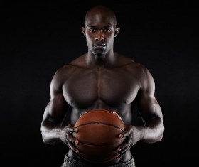 Black man holding basketball in hand Stock Photo