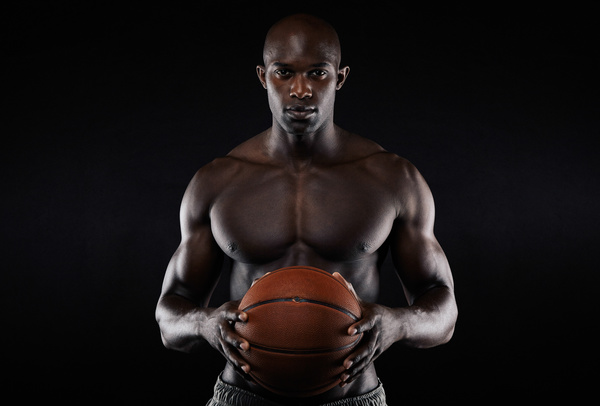 Black man holding basketball in hand Stock Photo