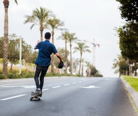 Boy on skateboard highway Stock Photo