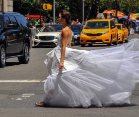 Bride crossing the road Stock Photo