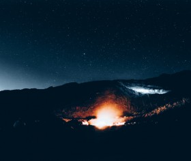 Bright fire light on dark mountain Stock Photo