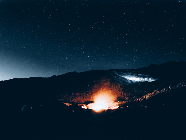 Bright fire light on dark mountain Stock Photo