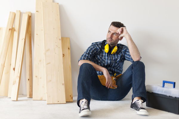 Carpenter sitting in the corner Stock Photo