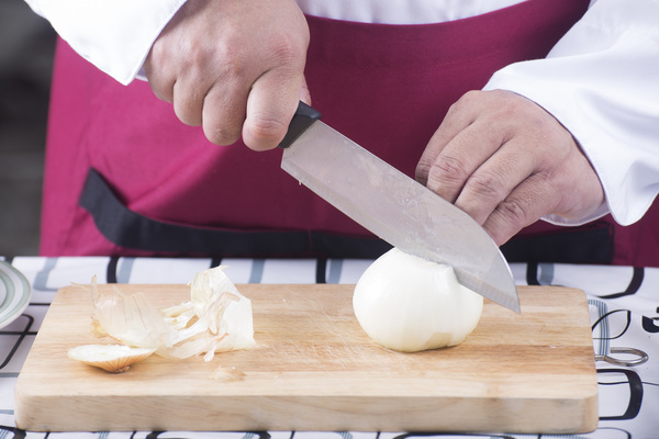 Chef cuts the onion Stock Photo
