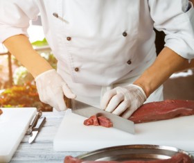 Chef cutting meat Stock Photo
