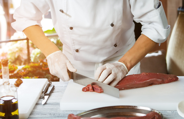 Chef cutting meat Stock Photo