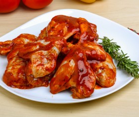 Chicken wings coated with ketchup Stock Photo