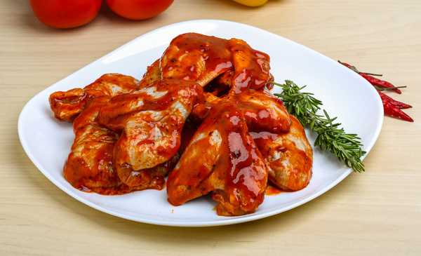 Chicken wings coated with ketchup Stock Photo