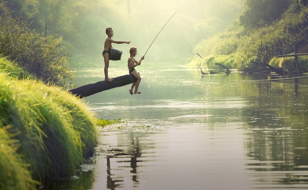 Children fishing in the river Stock Photo