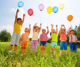 Children holding balloons Stock Photo