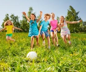 Children kicking the ball on the grass Stock Photo 02