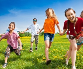 Children running on the grass Stock Photo