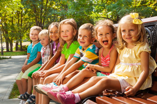 Children sitting on the bench Stock Photo