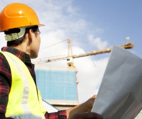 Construction engineer looking at drawings Stock Photo
