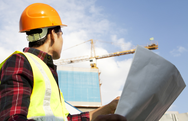 Construction engineer looking at drawings Stock Photo