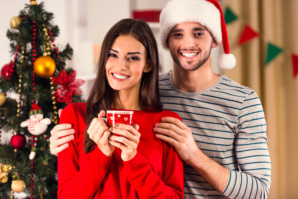 Couple in front of Christmas tree Stock Photo