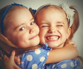 Embrace twin sisters Stock Photo