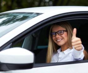 Female driver with thumbs up Stock Photo